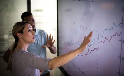 Women showing a chart of Bussines Growth